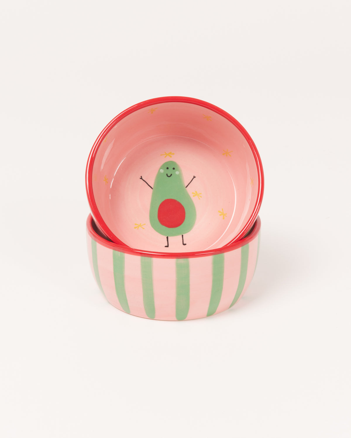Zwei stapelbare Schalen mit Avocado-Design, rosa Innenseite und grün gestreifter Außenseite.